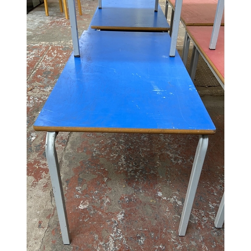 121 - Four mid 20th century laminate and tubular metal school desks