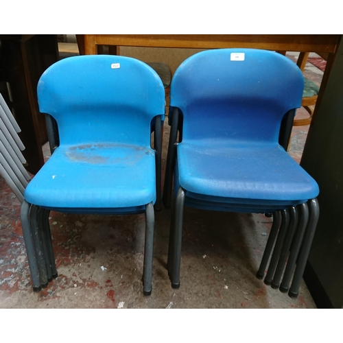 122 - Nine mid/late 20th century blue plastic and tubular metal stacking children's school chairs