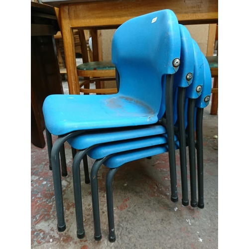 122 - Nine mid/late 20th century blue plastic and tubular metal stacking children's school chairs