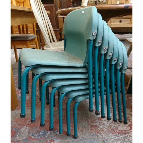 124 - Twenty one mid/late 20th century green plastic and tubular metal stacking children's school chairs