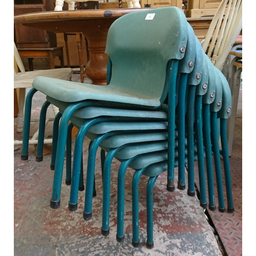 124 - Twenty one mid/late 20th century green plastic and tubular metal stacking children's school chairs