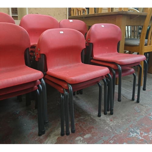 125 - Forty three mid/late 20th century red plastic and tubular metal stacking children's school chairs