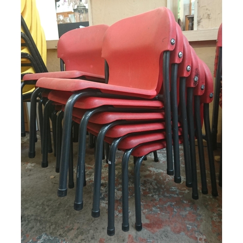 125 - Forty three mid/late 20th century red plastic and tubular metal stacking children's school chairs