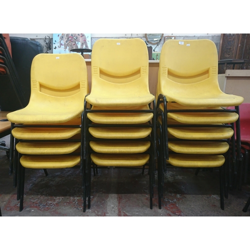 126 - Fourteen mid/late 20th century Scholar yellow plastic and tubular metal stacking children’s school c... 