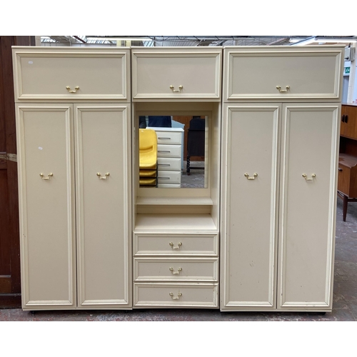 130 - A 1980s white laminate triple wardrobe - approx. 182cm high x 210cm wide x 55cm deep