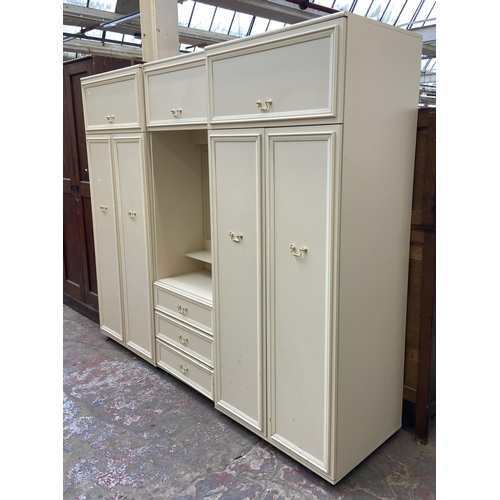 130 - A 1980s white laminate triple wardrobe - approx. 182cm high x 210cm wide x 55cm deep