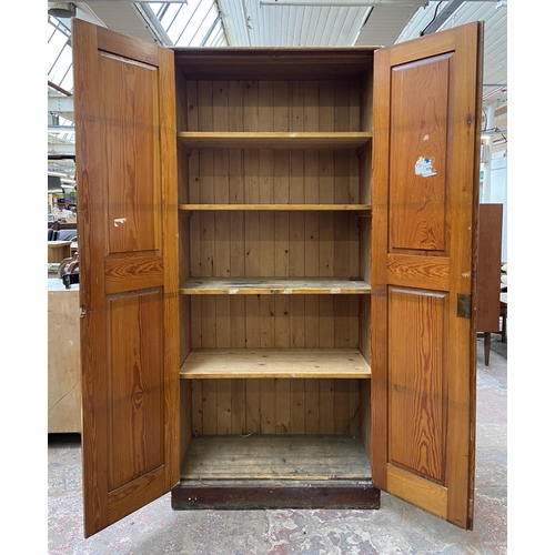 131 - An antique pitch pine school cupboard - approx. 198cm high x 91cm wide x 45cm deep