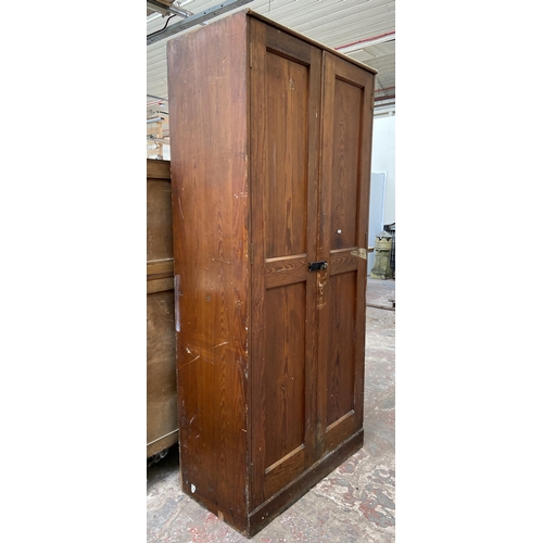 131 - An antique pitch pine school cupboard - approx. 198cm high x 91cm wide x 45cm deep