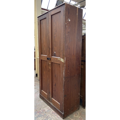 131 - An antique pitch pine school cupboard - approx. 198cm high x 91cm wide x 45cm deep