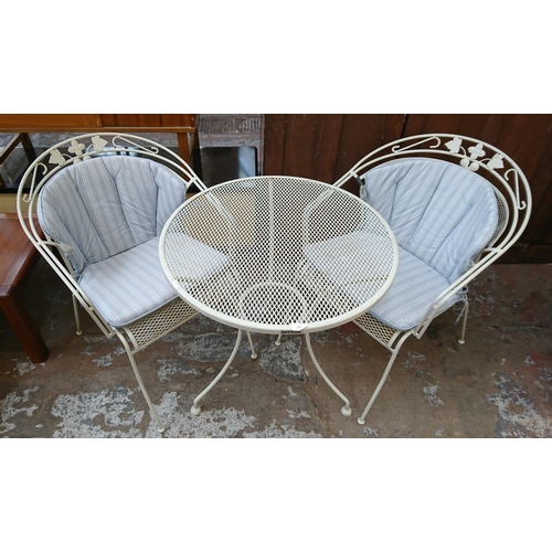 134 - A modern white metal three piece patio set comprising circular table and two armchairs - table appro... 