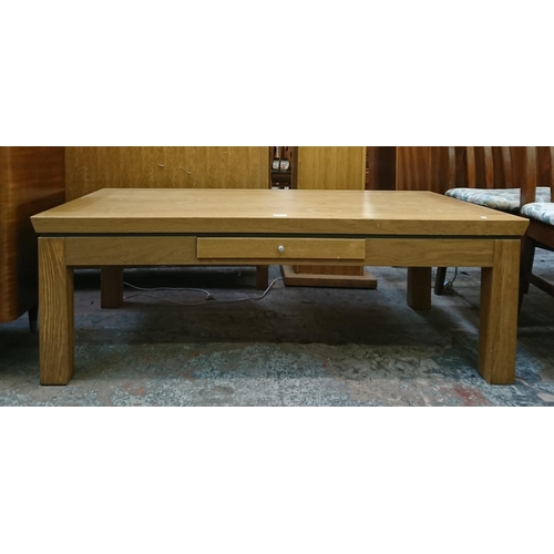 139 - A modern oak rectangular single drawer coffee table - approx. 45cm high x 70cm wide x 130cm long