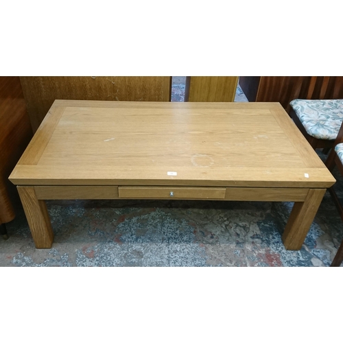 139 - A modern oak rectangular single drawer coffee table - approx. 45cm high x 70cm wide x 130cm long