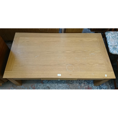 139 - A modern oak rectangular single drawer coffee table - approx. 45cm high x 70cm wide x 130cm long