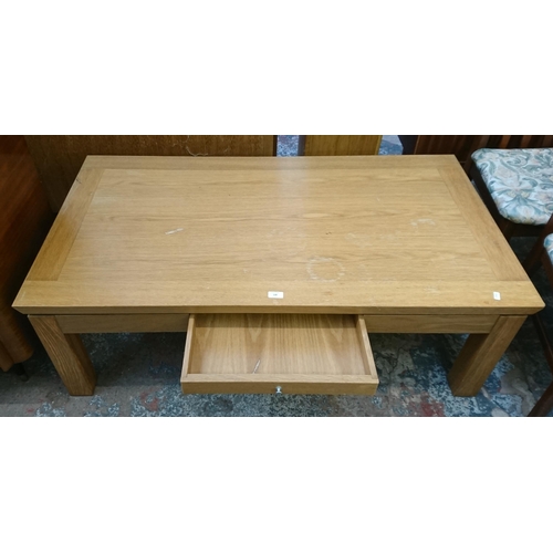 139 - A modern oak rectangular single drawer coffee table - approx. 45cm high x 70cm wide x 130cm long