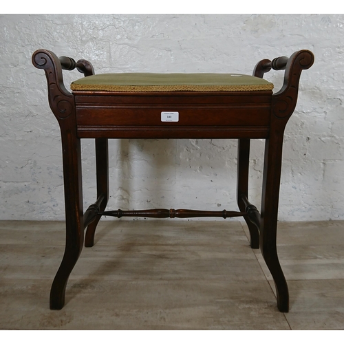 140 - An Edwardian mahogany and green fabric upholstered twin handled piano stool - approx. 60cm high x 58... 