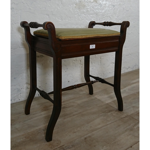 140 - An Edwardian mahogany and green fabric upholstered twin handled piano stool - approx. 60cm high x 58... 