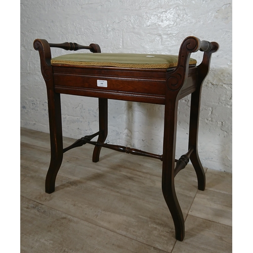 140 - An Edwardian mahogany and green fabric upholstered twin handled piano stool - approx. 60cm high x 58... 