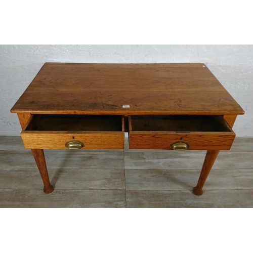 147 - A mid 20th century oak two drawer writing desk - approx. 76cm high x 121cm wide x 64cm deep