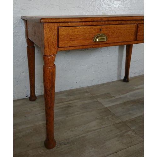 147 - A mid 20th century oak two drawer writing desk - approx. 76cm high x 121cm wide x 64cm deep