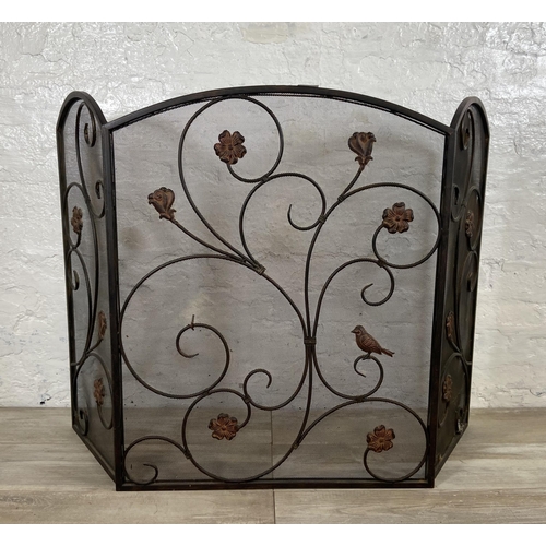 16 - An Art Nouveau style black metal and meshed floral design three section folding fire screen - approx... 