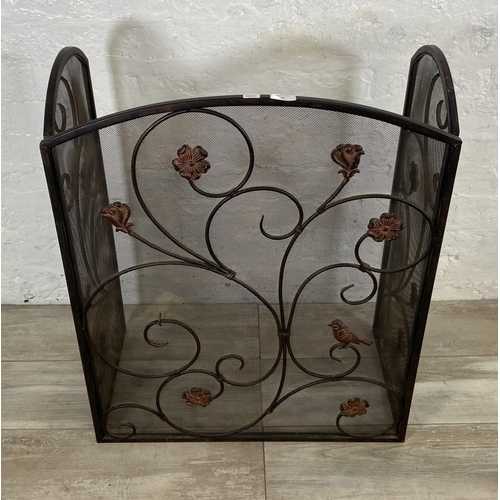 16 - An Art Nouveau style black metal and meshed floral design three section folding fire screen - approx... 