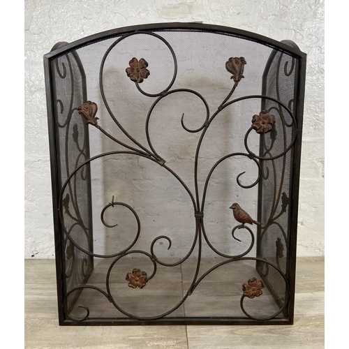 16 - An Art Nouveau style black metal and meshed floral design three section folding fire screen - approx... 