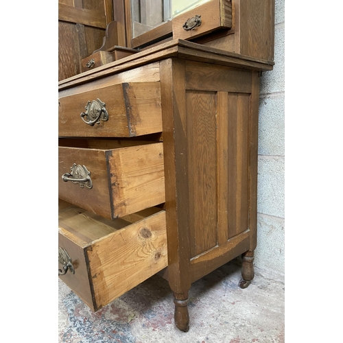 21 - A late Victorian carved oak two piece bedroom suite comprising dressing chest with upper bevelled ed... 