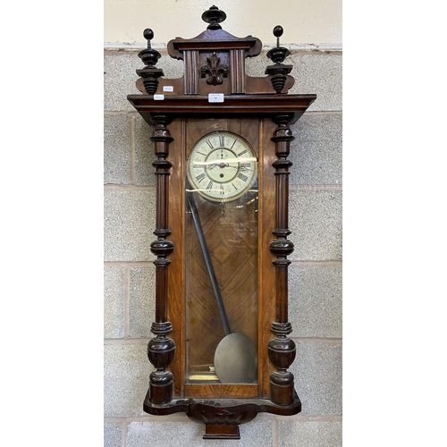 24 - A Victorian carved walnut and mahogany cased Vienna wall clock with pendulum and weight - approx. 11... 