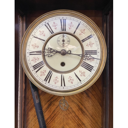 24 - A Victorian carved walnut and mahogany cased Vienna wall clock with pendulum and weight - approx. 11... 