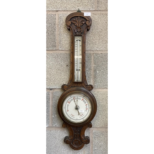 27 - A Victorian carved oak cased barometer - approx. 80cm high