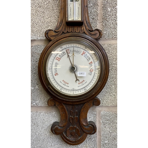 27 - A Victorian carved oak cased barometer - approx. 80cm high