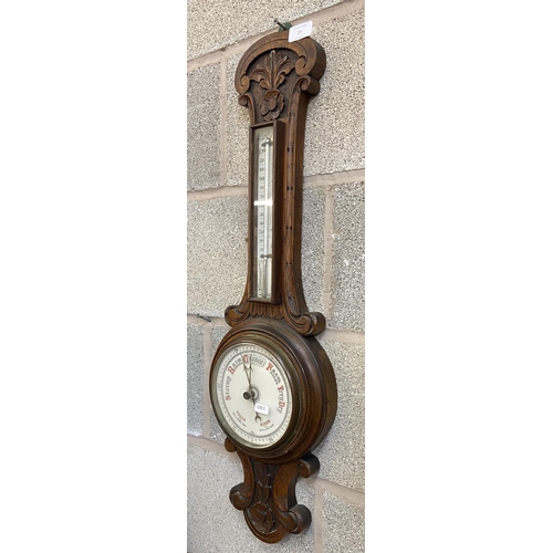 27 - A Victorian carved oak cased barometer - approx. 80cm high