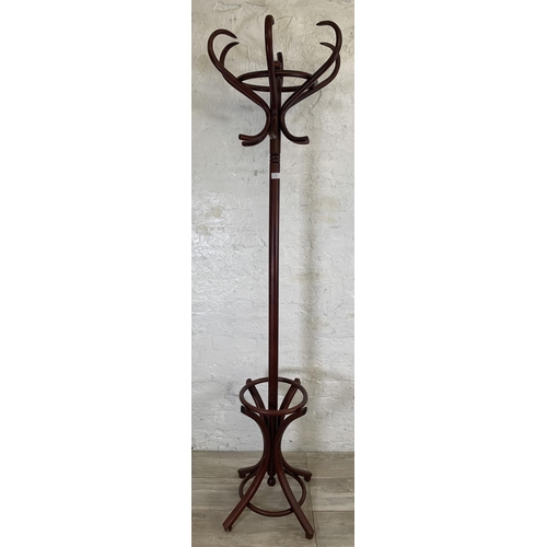 29 - A stained beech and bentwood coat stand - approx. 194cm high