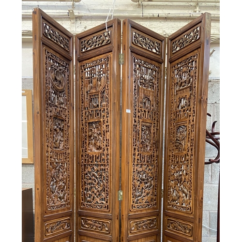 30 - A Chinese carved hardwood four section folding room divider/screen - approx. 256cm high x 172cm wide