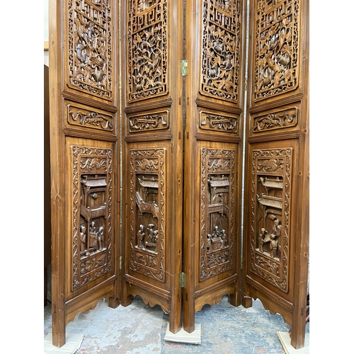 30 - A Chinese carved hardwood four section folding room divider/screen - approx. 256cm high x 172cm wide