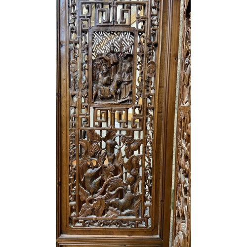 30 - A Chinese carved hardwood four section folding room divider/screen - approx. 256cm high x 172cm wide