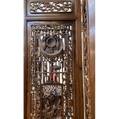 30 - A Chinese carved hardwood four section folding room divider/screen - approx. 256cm high x 172cm wide