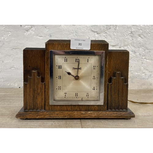 31 - An Art Deco Ferranti oak cased electric mantel clock - approx. 16cm high x 23cm wide x 8cm deep