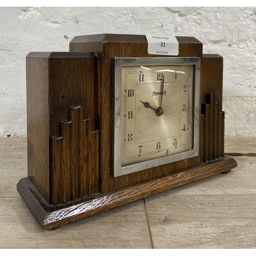 31 - An Art Deco Ferranti oak cased electric mantel clock - approx. 16cm high x 23cm wide x 8cm deep