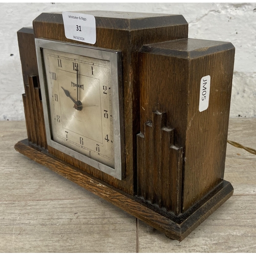 31 - An Art Deco Ferranti oak cased electric mantel clock - approx. 16cm high x 23cm wide x 8cm deep