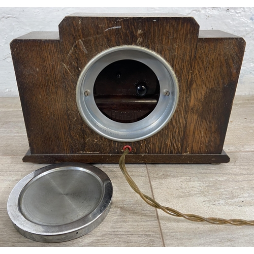 31 - An Art Deco Ferranti oak cased electric mantel clock - approx. 16cm high x 23cm wide x 8cm deep