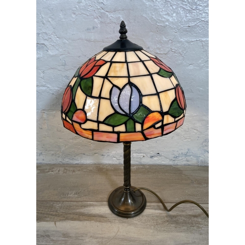 32 - A Tiffany style stained glass and brushed brass effect table lamp - approx. 50cm high