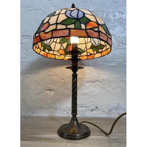 32 - A Tiffany style stained glass and brushed brass effect table lamp - approx. 50cm high