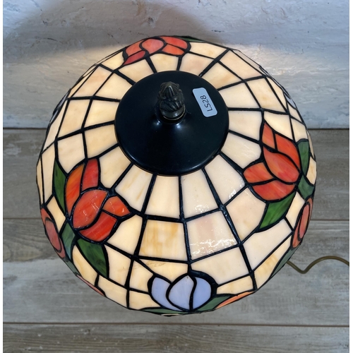 32 - A Tiffany style stained glass and brushed brass effect table lamp - approx. 50cm high