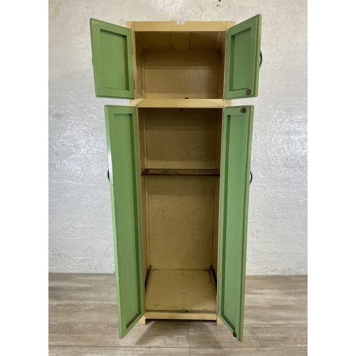 35 - A 1950s green and cream painted four door kitchen cabinet - approx. 176cm high x 54cm wide x 54cm de... 