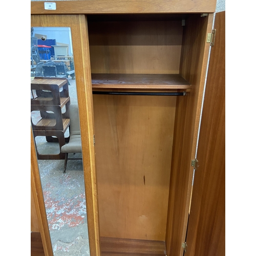 39 - A mid 20th century teak double wardrobe with central mirror - approx. 172cm high x 115cm wide x 50cm... 