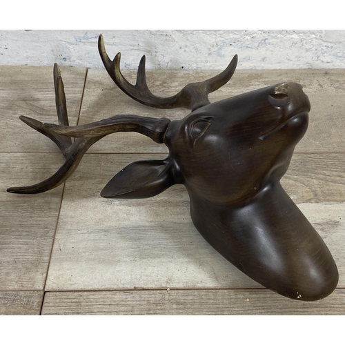 40 - A pair of bronzed resin stag head wall mountable sculptures - approx. 42cm high