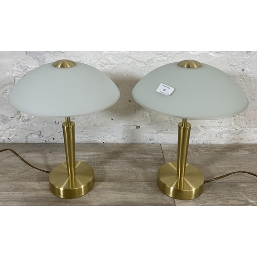 41 - A pair of Eglo brushed brass effect table lamps with glass shades - approx. 36cm high