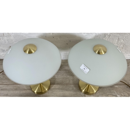 41 - A pair of Eglo brushed brass effect table lamps with glass shades - approx. 36cm high