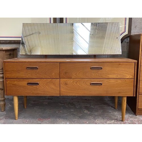 44 - A mid 20th century teak dressing table with upper mirror - approx. 106cm high x 132cm wide x 40cm de... 